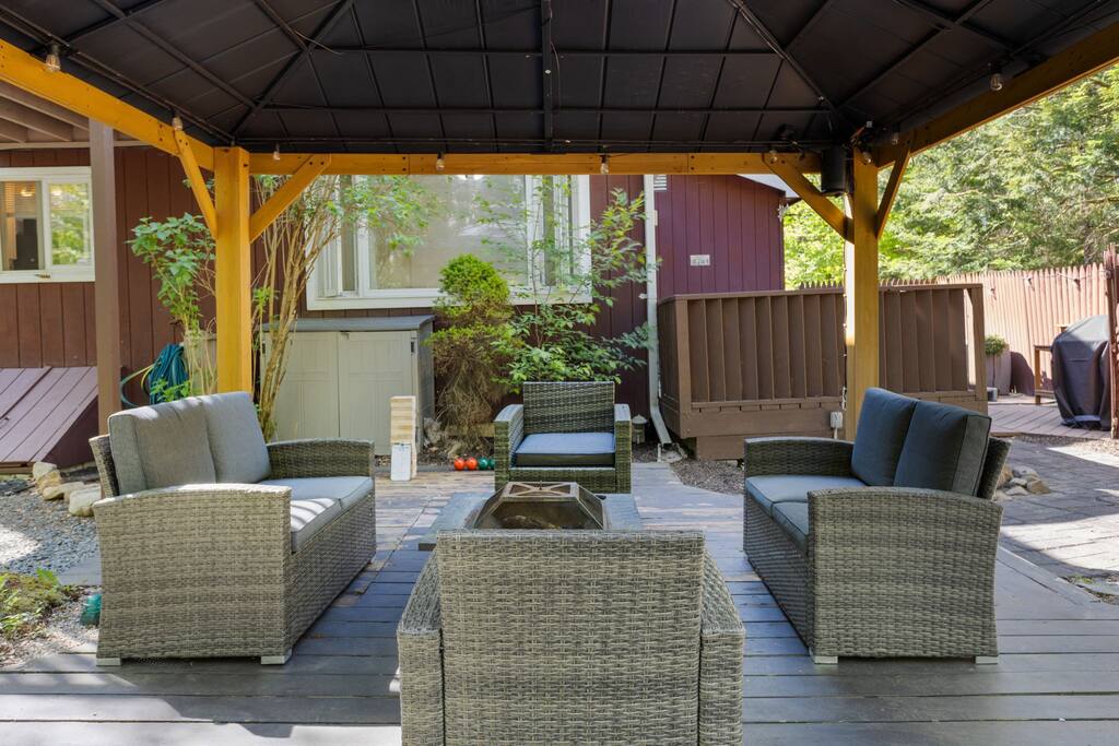 Covered Lounge Under Gazebo
An inviting outdoor living room with rattan seating and shade from the sun, making it the perfect place to gather, rain or shine.